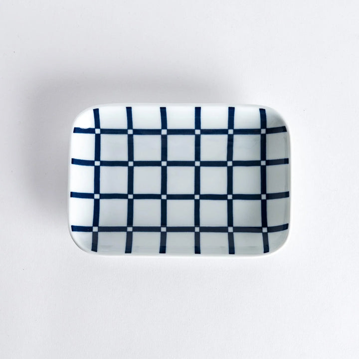 Top view of a rectangular dessert plate with a modern indigo lattice pattern.