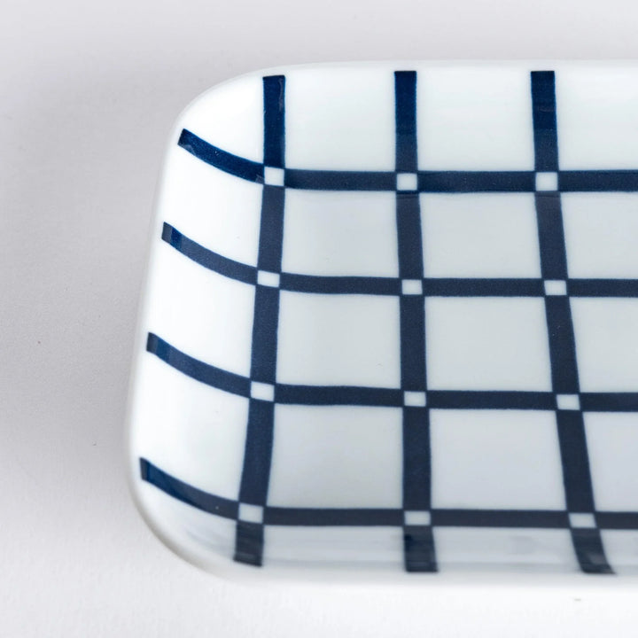 Modern Indigo Lattice dessert plate featuring geometric indigo lattice pattern on white porcelain surface.