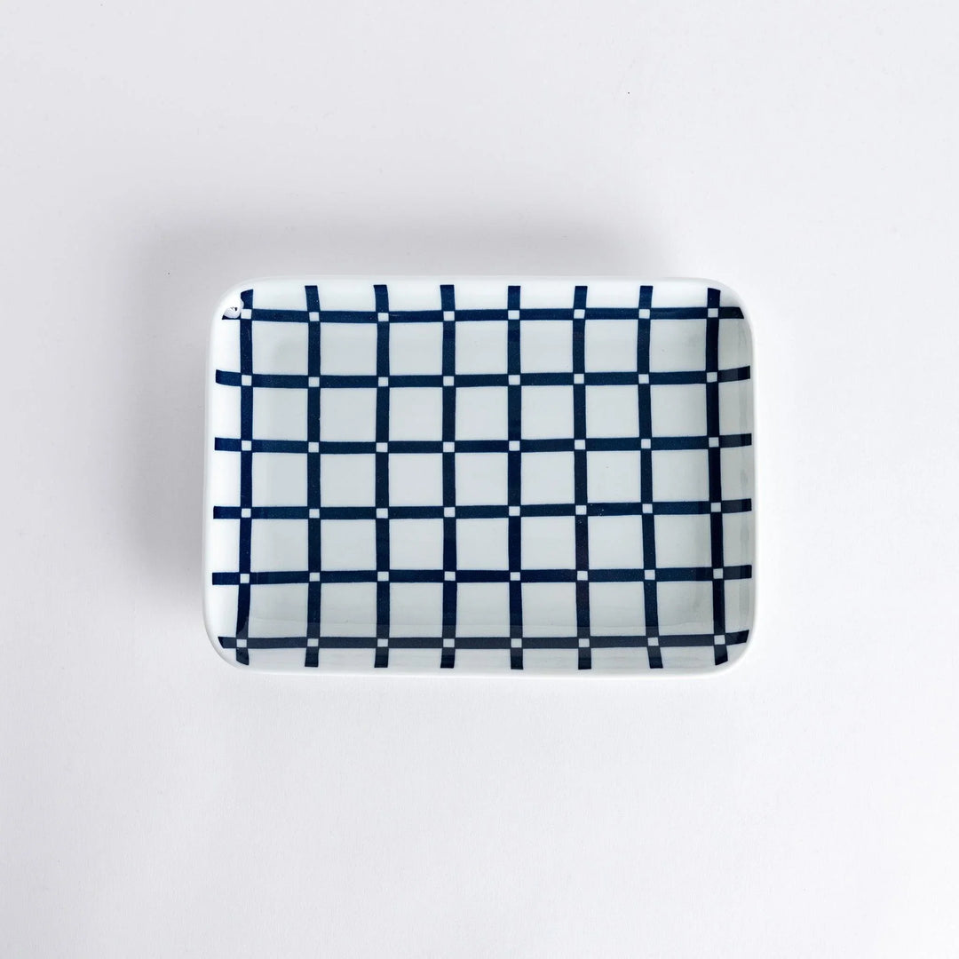 Modern Indigo Lattice dinner plate featuring bold geometric indigo lattice pattern on white porcelain.