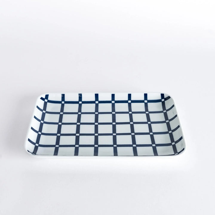 Modern Indigo Lattice dinner plate featuring bold geometric indigo lattice pattern on white porcelain.