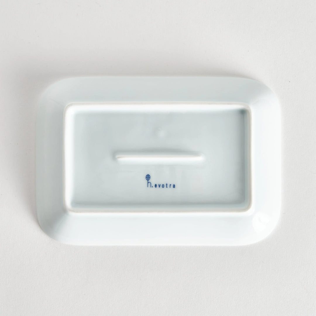 Bottom view of the dessert plate, displaying a plain white surface with the kiln name elegantly stamped.