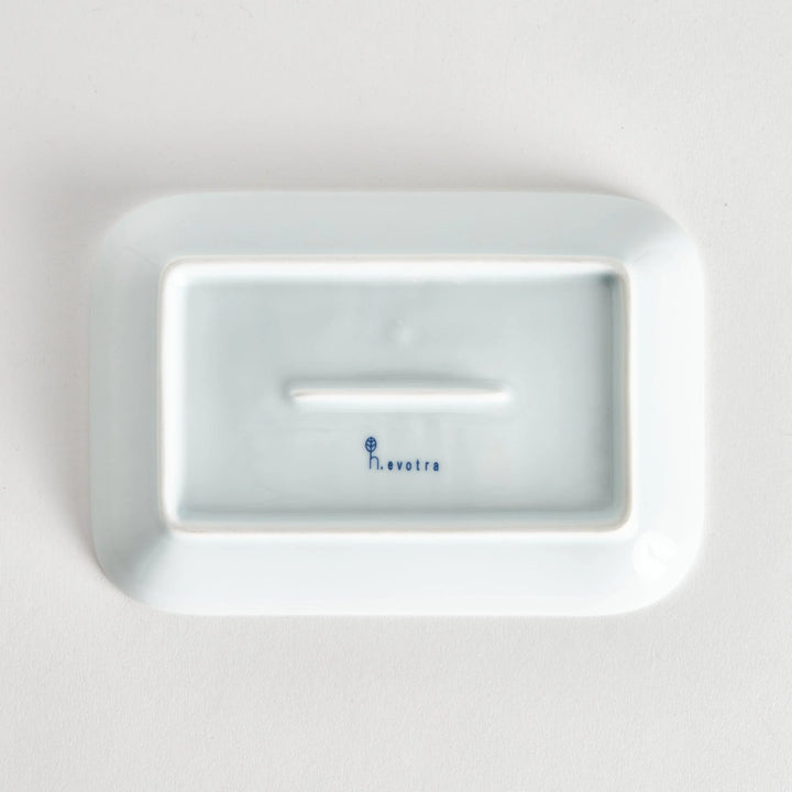 Bottom view of the dessert plate, displaying a plain white surface with the kiln name elegantly stamped.