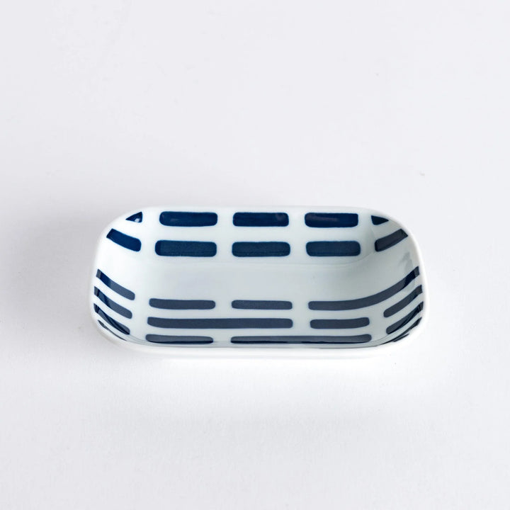 A slightly angled view of the Modern Indigo River Sauce Dish with blue striped patterns.