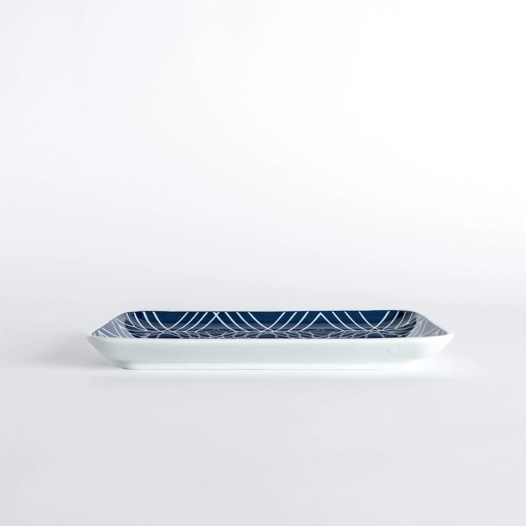 Side view of the Modern Indigo Tile Dinner Plate highlighting its slim profile and glossy finish.