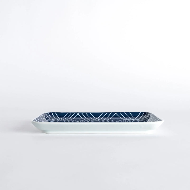 Side view of the Modern Indigo Tile Dinner Plate highlighting its slim profile and glossy finish.