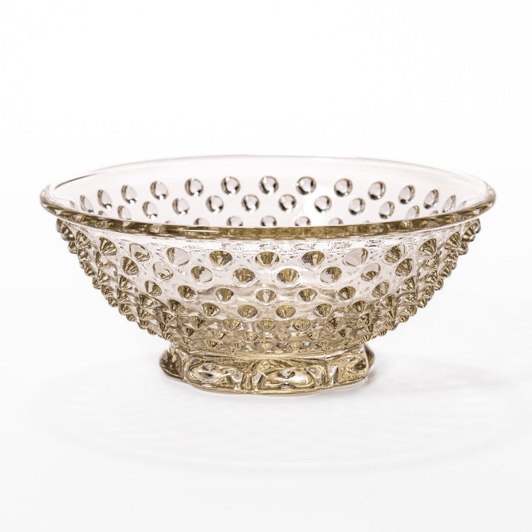Amber glass dessert bowl and saucer with raised dots and starburst base, perfect for serving refined sweets.