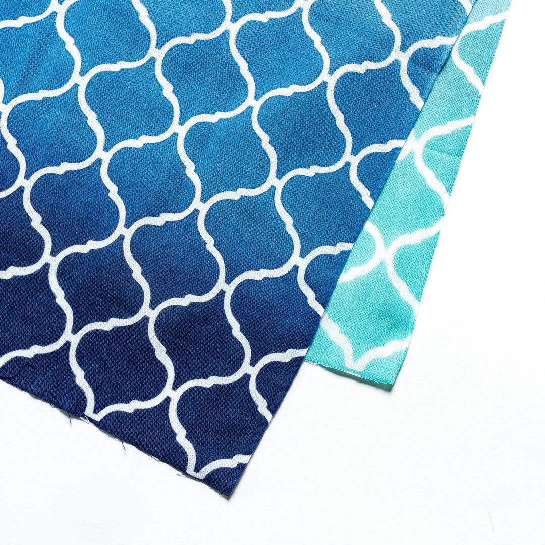 Close-up view of the intricate white lattice pattern on the blue tenugui hand towel.