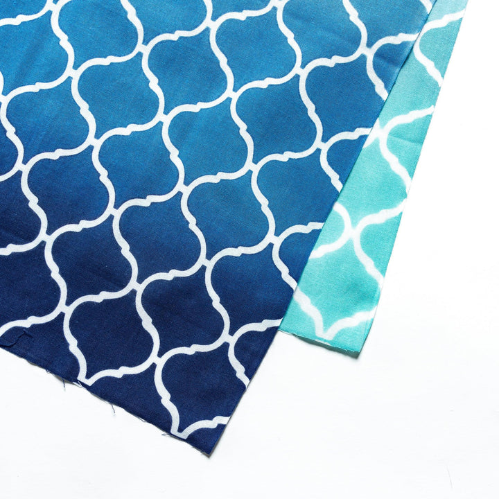 Close-up view of the intricate white lattice pattern on the blue tenugui hand towel.
