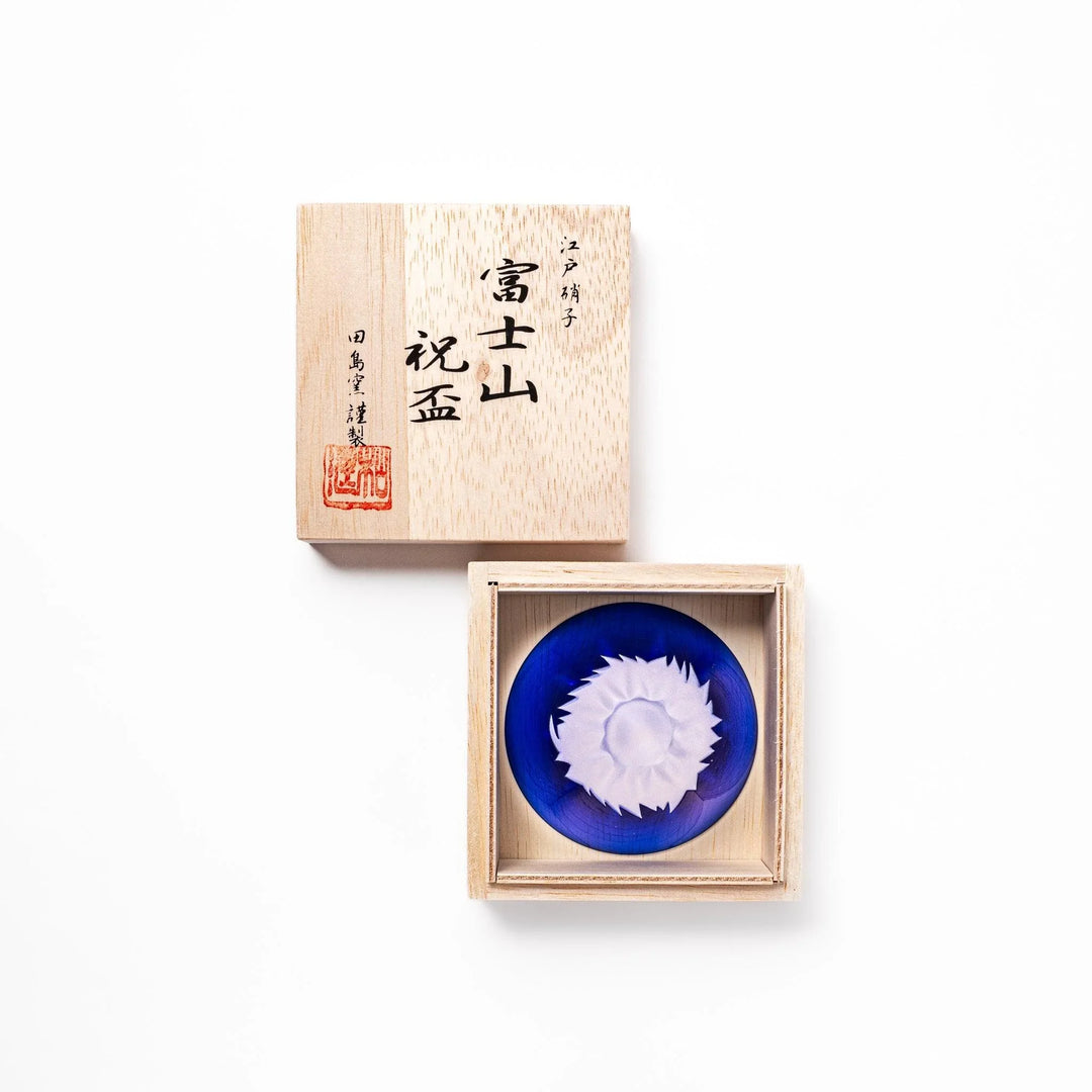 Blue glass sake cup shaped like Mount Fuji with a frosted snowcap, perfect for celebrations and Japanese dining.