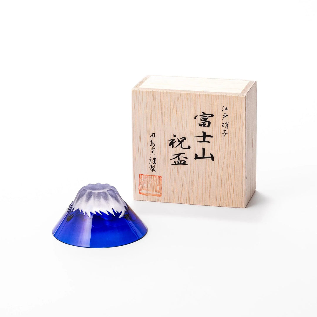 Blue glass sake cup shaped like Mount Fuji with a frosted snowcap, perfect for celebrations and Japanese dining.