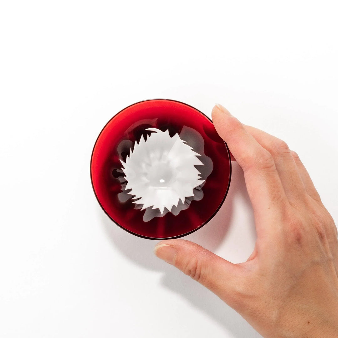 Red glass sake cup shaped like Mount Fuji with a frosted snowcap, perfect for elegant Japanese celebrations.