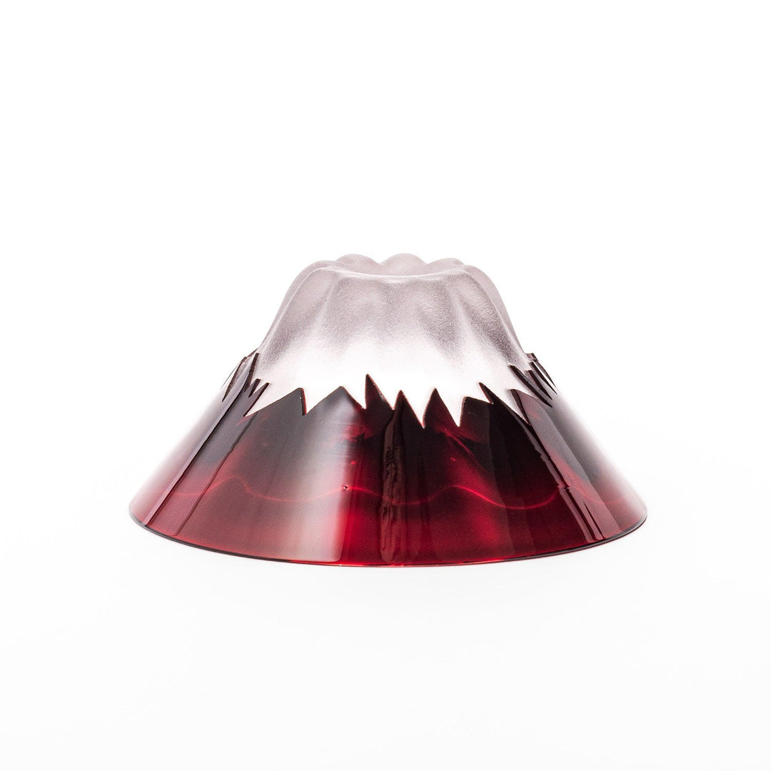 Red glass sake cup shaped like Mount Fuji with a frosted snowcap, perfect for elegant Japanese celebrations.