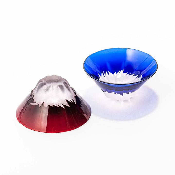 Mount Fuji sake cups in red and blue glass with frosted snowcaps, perfect for festive toasts or gifting.