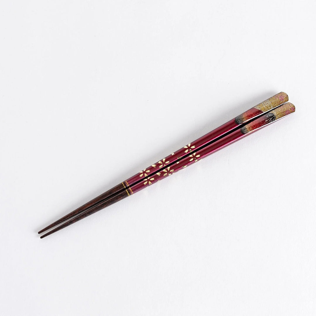 A boxed set of two pairs of chopsticks, one with blue and one with red handles, featuring Mount Fuji designs.