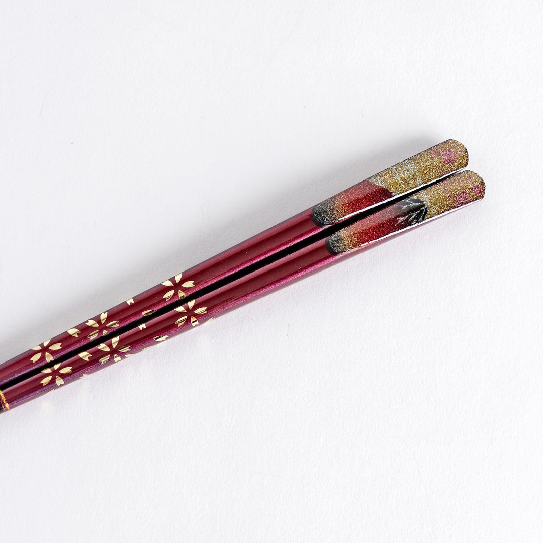 A boxed set of two pairs of chopsticks, one with blue and one with red handles, featuring Mount Fuji designs.