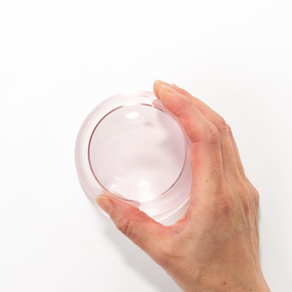 Light pink Mount Fuji beer glass with etched cherry blossoms, perfect for spring drinks and elegant settings.