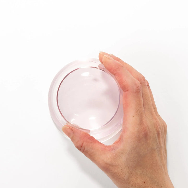 Light pink Mount Fuji beer glass with etched cherry blossoms, perfect for spring drinks and elegant settings.