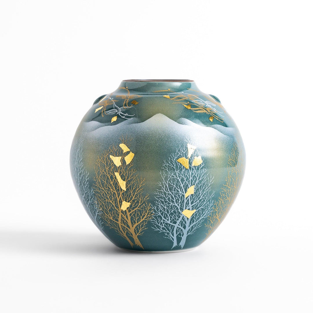 Handcrafted vase with serene mountain scene gold leaf accents and delicate trees in soft teal tones.