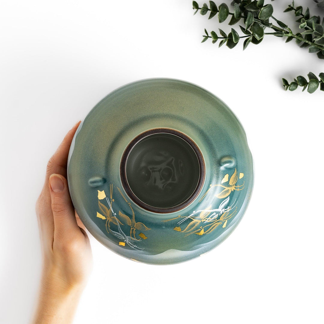 Handcrafted vase with serene mountain scene gold leaf accents and delicate trees in soft teal tones.