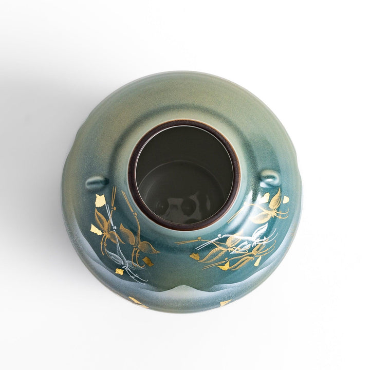 Handcrafted vase with serene mountain scene gold leaf accents and delicate trees in soft teal tones.