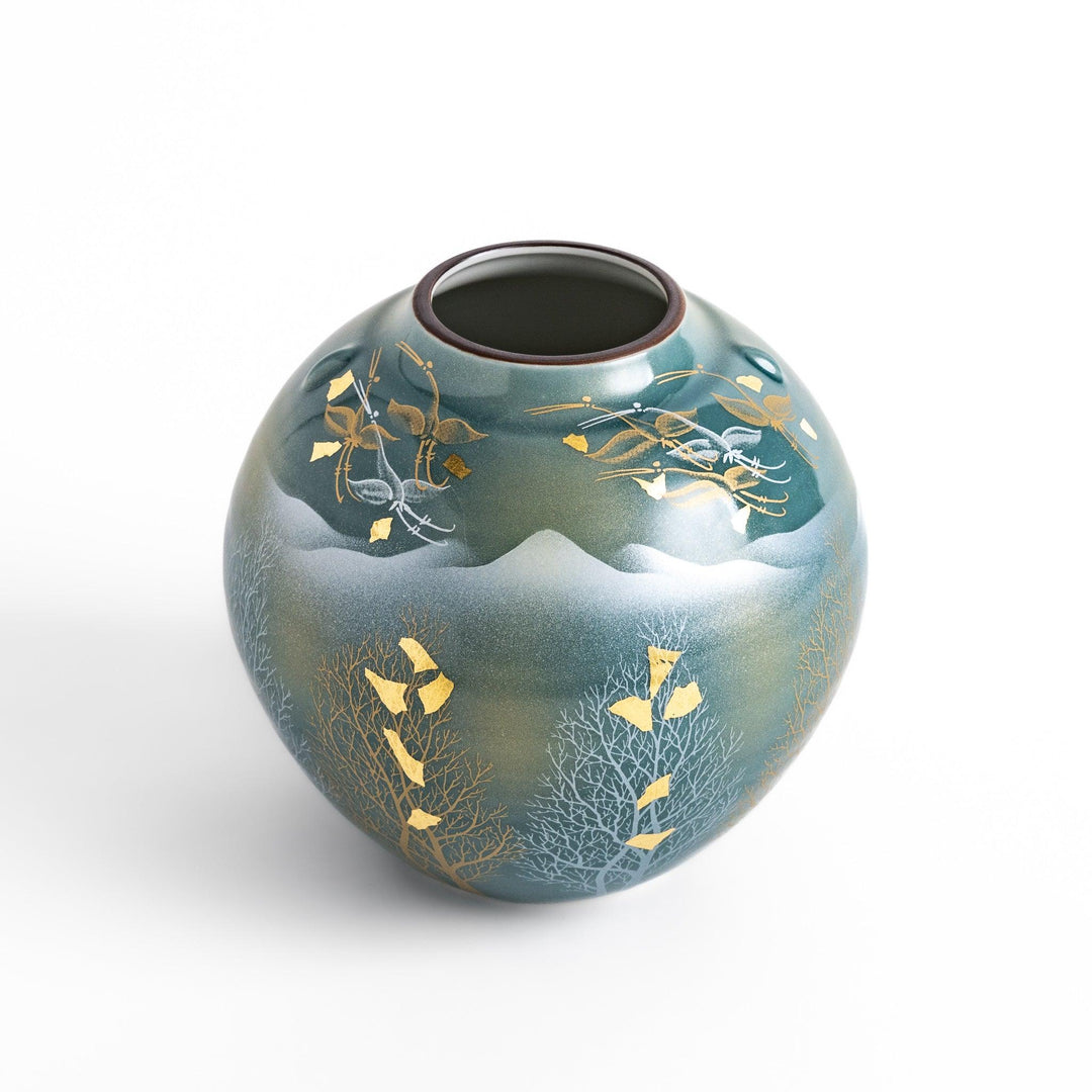 Handcrafted vase with serene mountain scene gold leaf accents and delicate trees in soft teal tones.