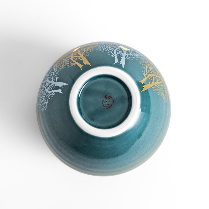 Handcrafted vase with serene mountain scene gold leaf accents and delicate trees in soft teal tones.