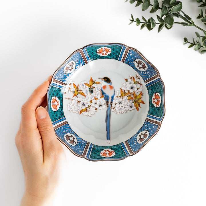 Cereal Bowl featuring a vibrant bird perched on blossoming sakura flowers, framed by intricate blue patterns.