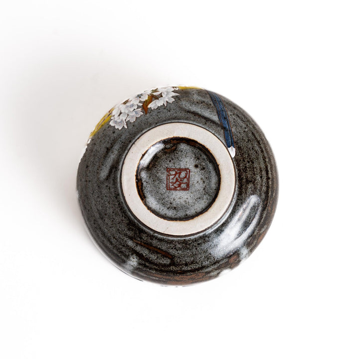 Yellow matcha bowl with bird and flowering branch design ideal for preparing and enjoying matcha tea.