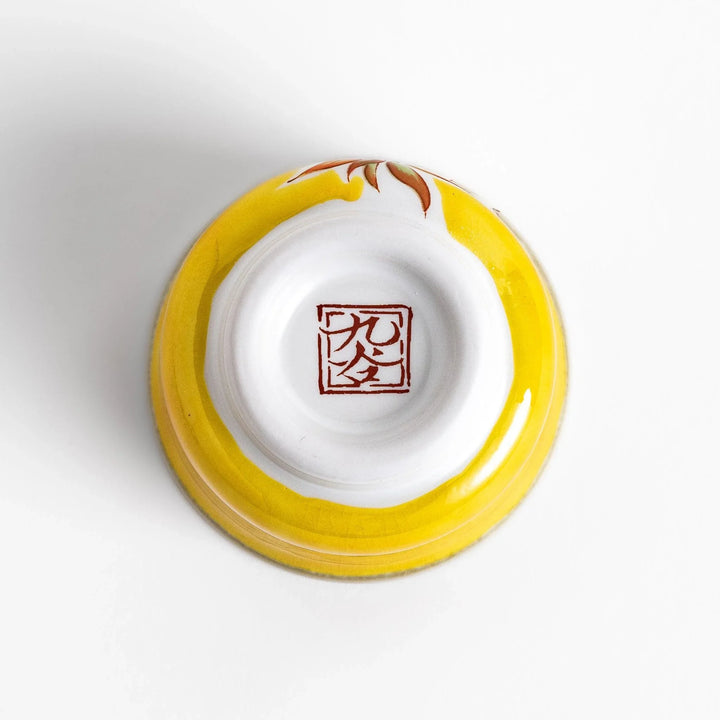 Yellow sake set with bird and cherry blossom floral design including bottle and cups for spring dining.