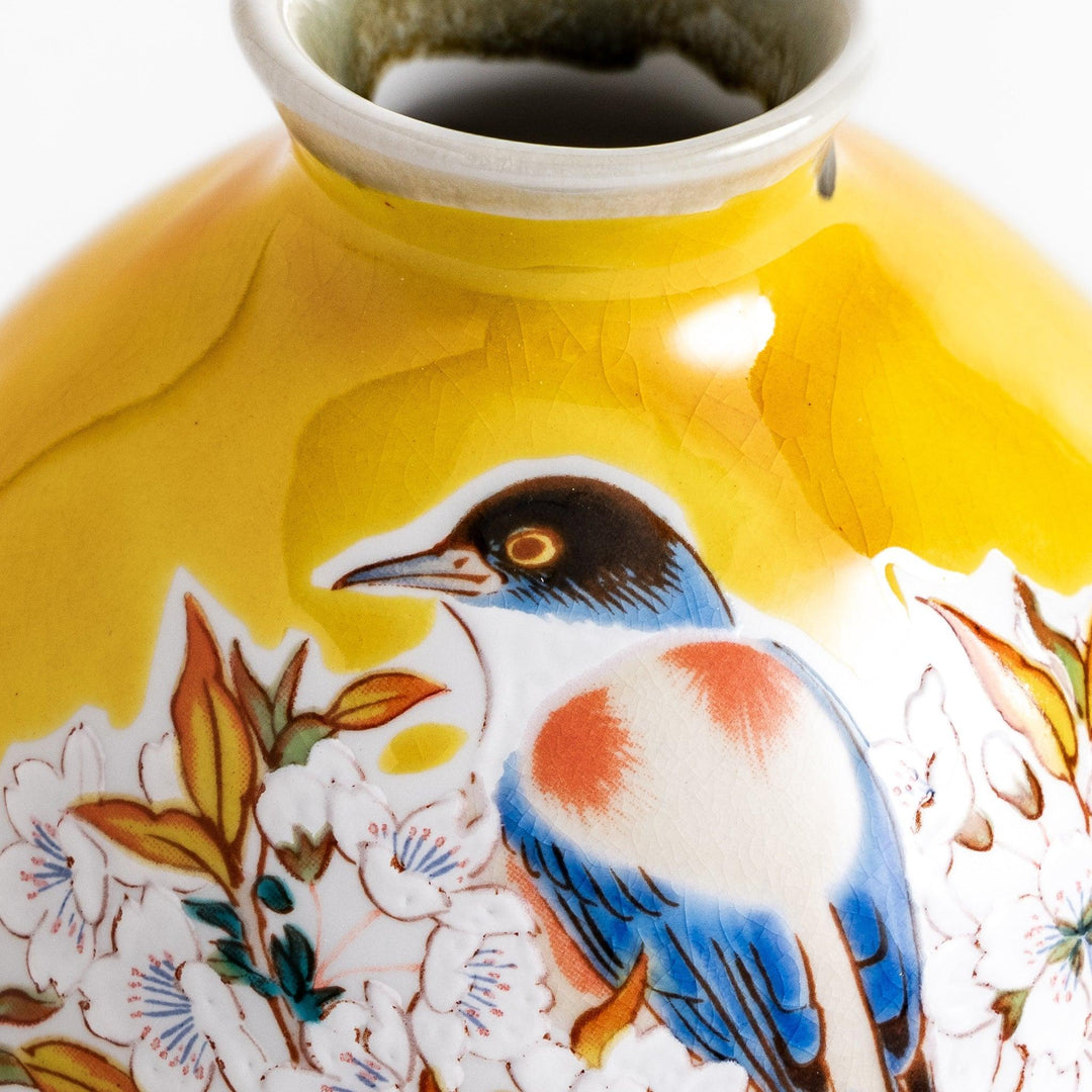 Yellow sake set with bird and cherry blossom floral design including bottle and cups for spring dining.