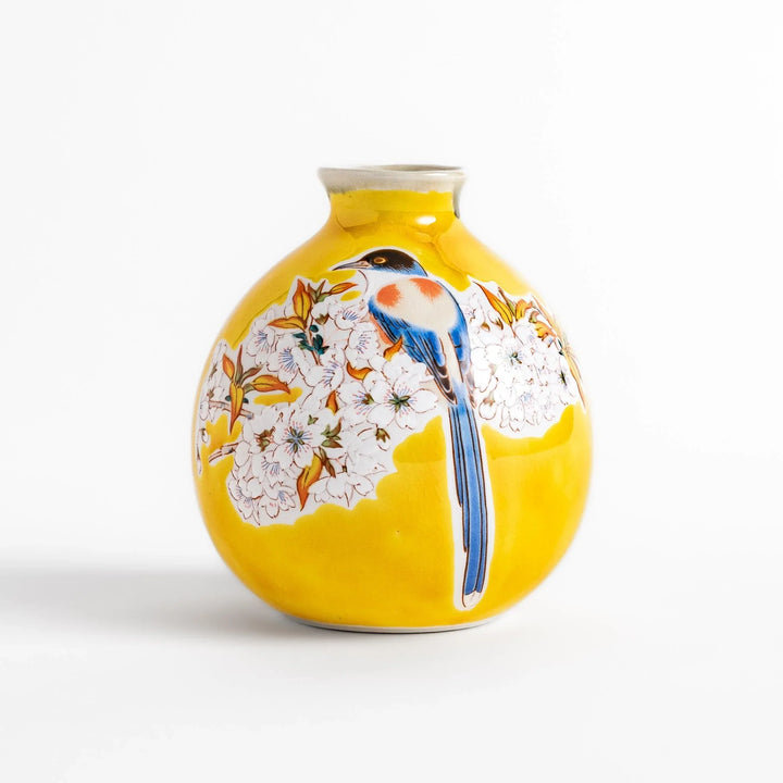 Yellow sake set with bird and cherry blossom floral design including bottle and cups for spring dining.