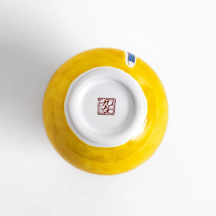 Yellow sake set with bird and cherry blossom floral design including bottle and cups for spring dining.