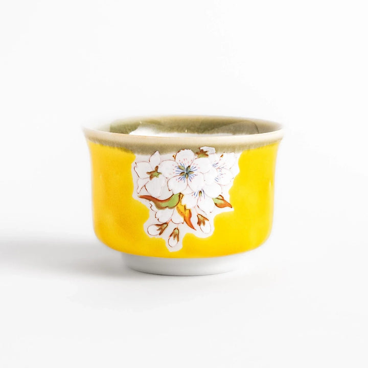 Yellow sake set with bird and cherry blossom floral design including bottle and cups for spring dining.