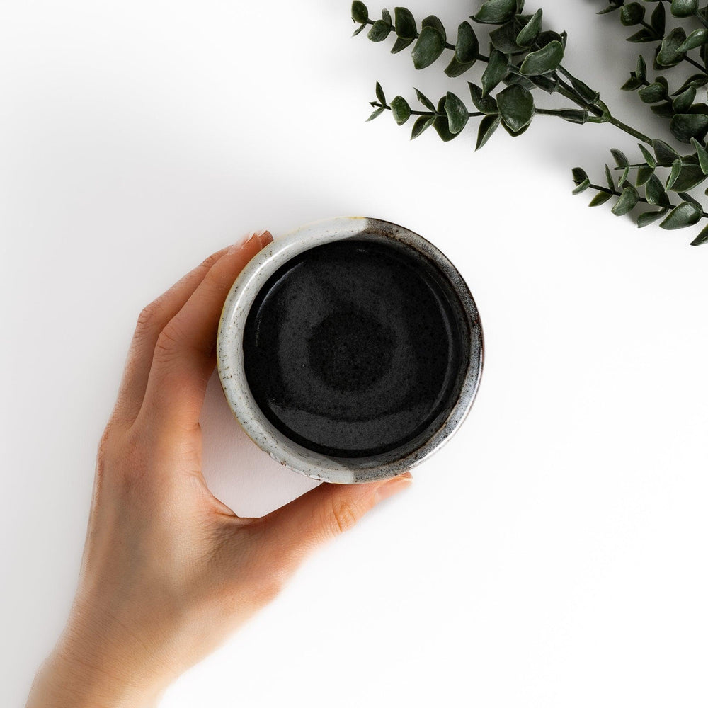 Tea Cup featuring a bird perched on blooming sakura flowers, set against a yellow and gray background.
