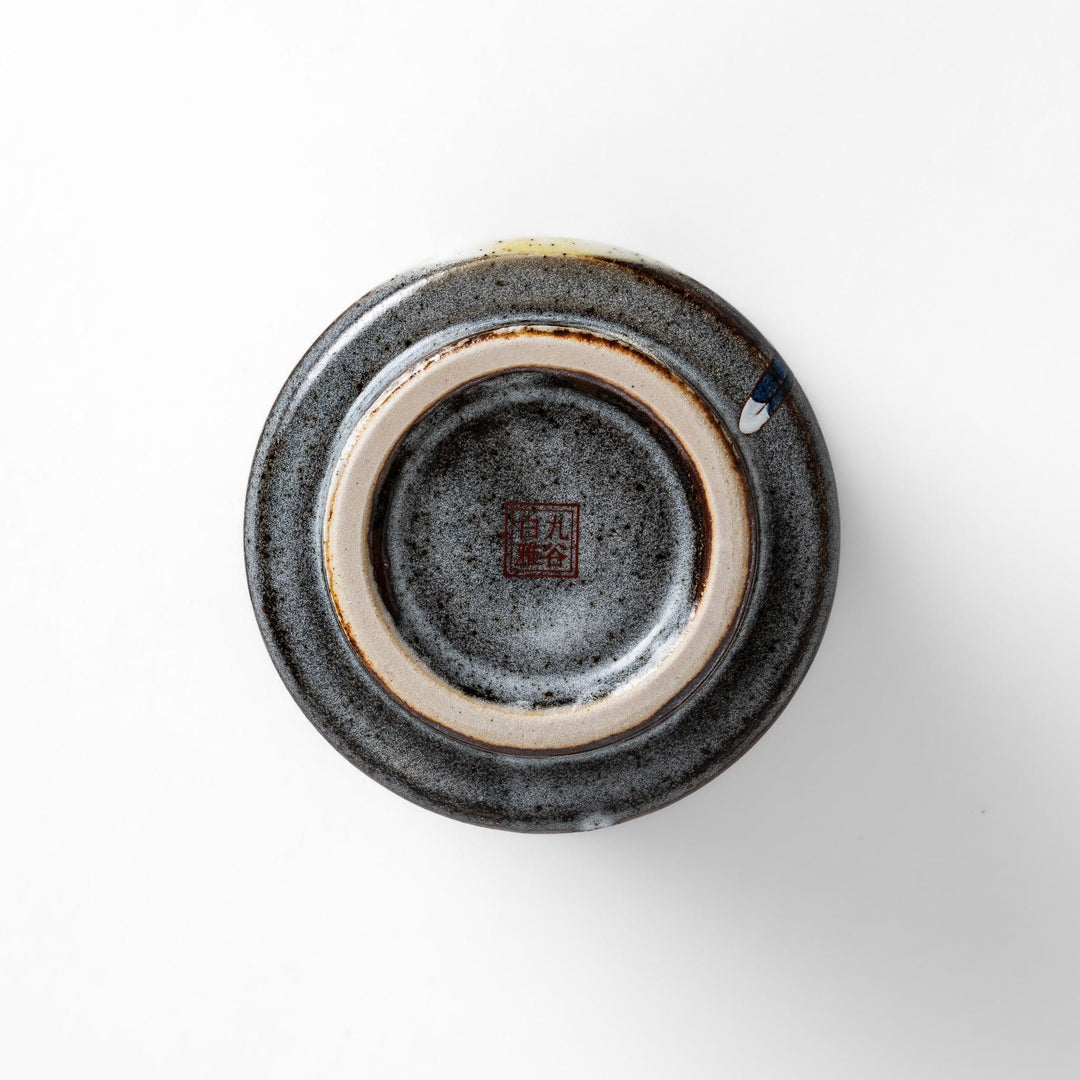 Tea Cup featuring a bird perched on blooming sakura flowers, set against a yellow and gray background.