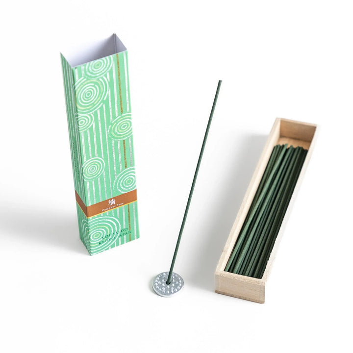 Japanese camphor tree incense sticks in a wooden box with a green patterned sleeve from Kyoto’s Kousaido