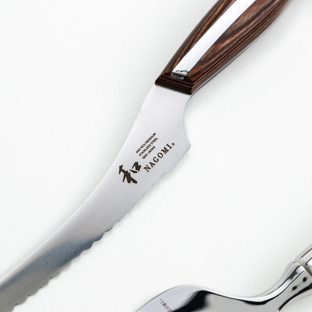 Set of Nagomi knives including a serrated knife and a pie server, both with wooden handles, displayed on a white background.