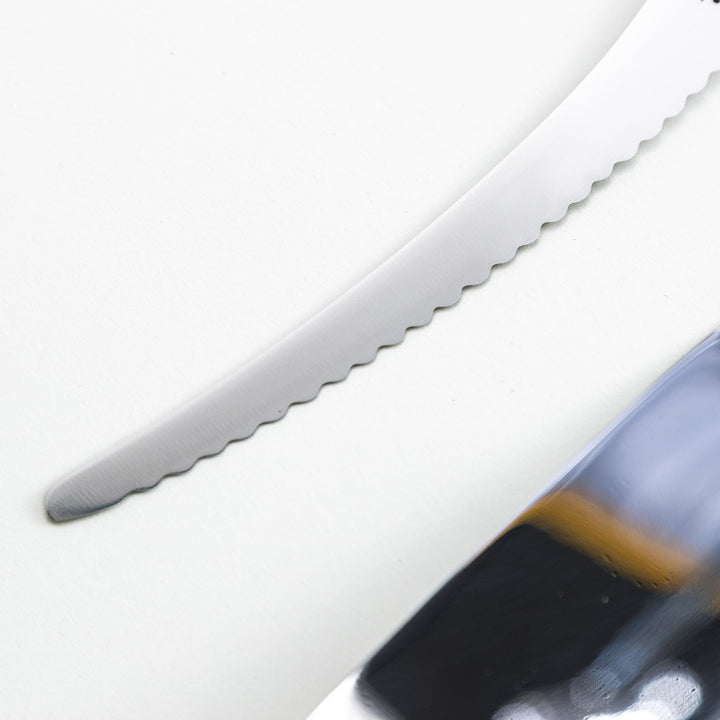Set of Nagomi knives including a serrated knife and a pie server, both with wooden handles, displayed on a white background.