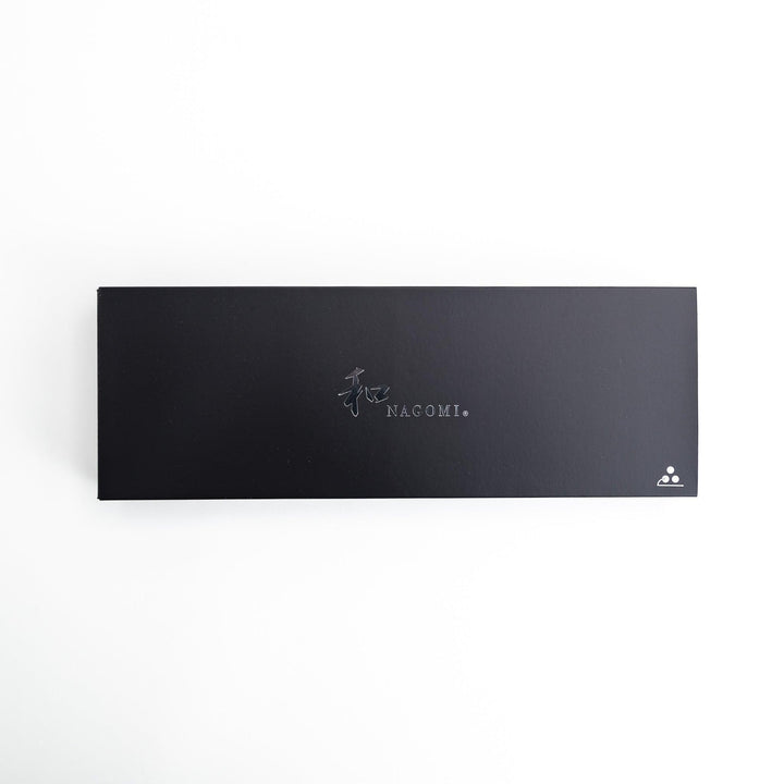 Set of Nagomi knives including a serrated knife and a pie server, both with wooden handles, displayed on a white background.