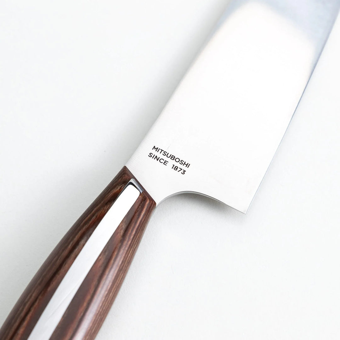 Nagomi Santoku knife with a sharp stainless steel blade and a polished wooden handle, displayed on a white background.