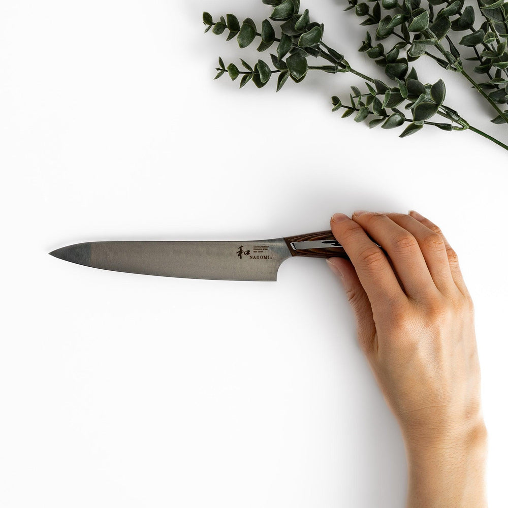 Nagomi utility knife with sharp durable blade and striped wooden handle designed for precise comfortable kitchen tasks.