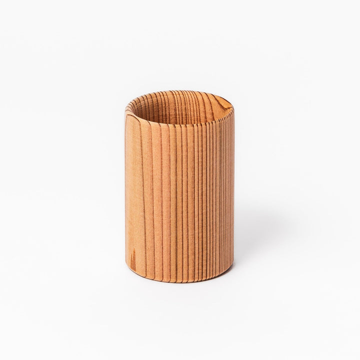 Cedar sake cup with smooth rim and visible grain, offering a warm, aromatic touch to traditional drinkware.