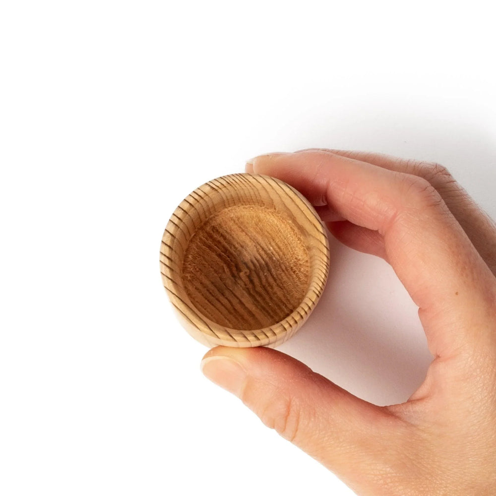 Cedar sake cup with smooth rim and visible grain, offering a warm, aromatic touch to traditional drinkware.