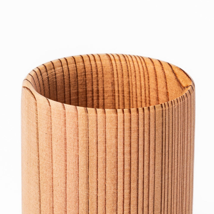 Cedar sake cup with smooth rim and visible grain, offering a warm, aromatic touch to traditional drinkware.