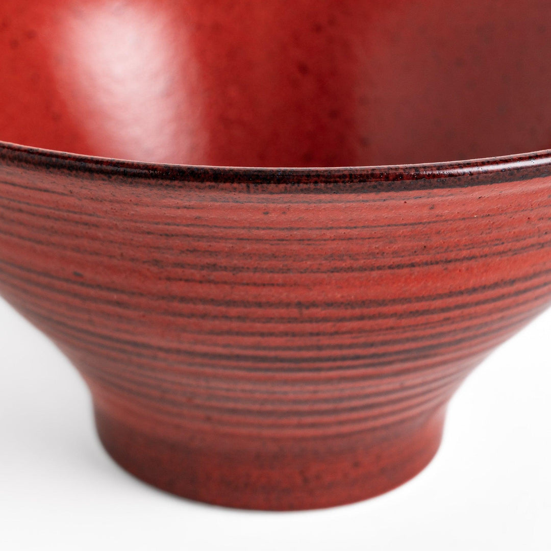 Red ramen bowl with a glossy lacquered finish, featuring subtle concentric ridges and a sturdy base for easy handling.