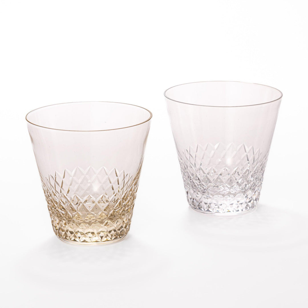 Pair of textured nostalgia rocks glasses in amber and clear with diamond-cut pattern near base, ideal for whisky or cocktails