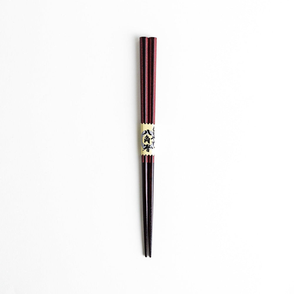 Octagonal wooden chopsticks with a brown tone, finished with a textured grain. Available in red or black.