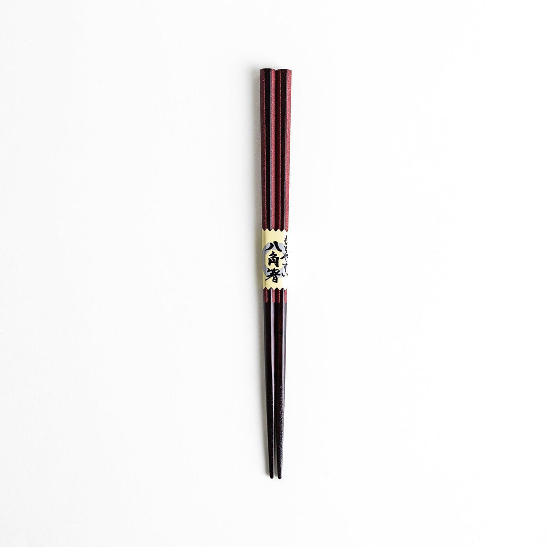 Octagonal wooden chopsticks with a brown tone, finished with a textured grain. Available in red or black.