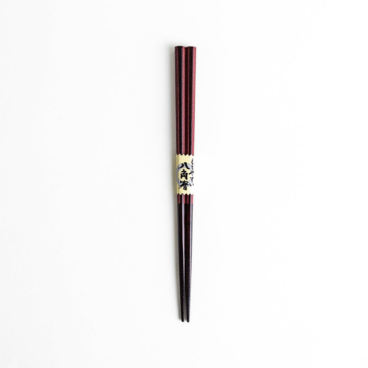 Octagonal wooden chopsticks with a brown tone, finished with a textured grain. Available in red or black.