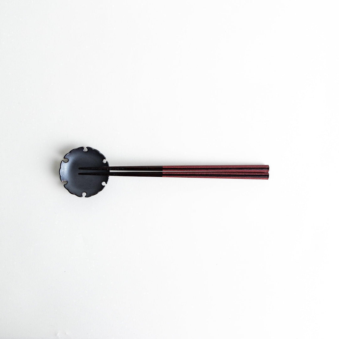 Octagonal wooden chopsticks with a brown tone, finished with a textured grain. Available in red or black.